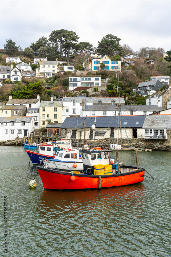 Red Fishing boat moored in the historic and quaint Polperro Harbour in Cornwall, UK