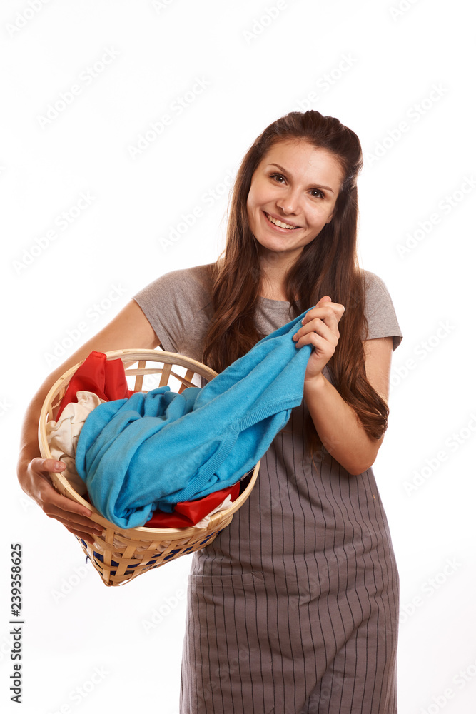 woman doing a housework holding laundry isolated over white background woman doing a housework holding laundry isolated over white background