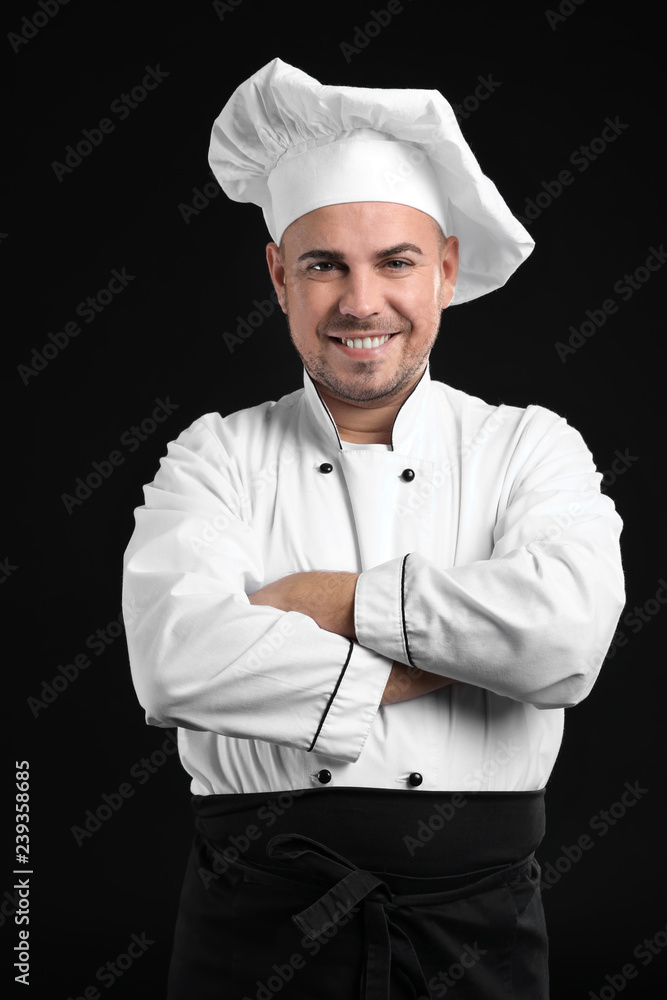 Portrait of male chef on dark background