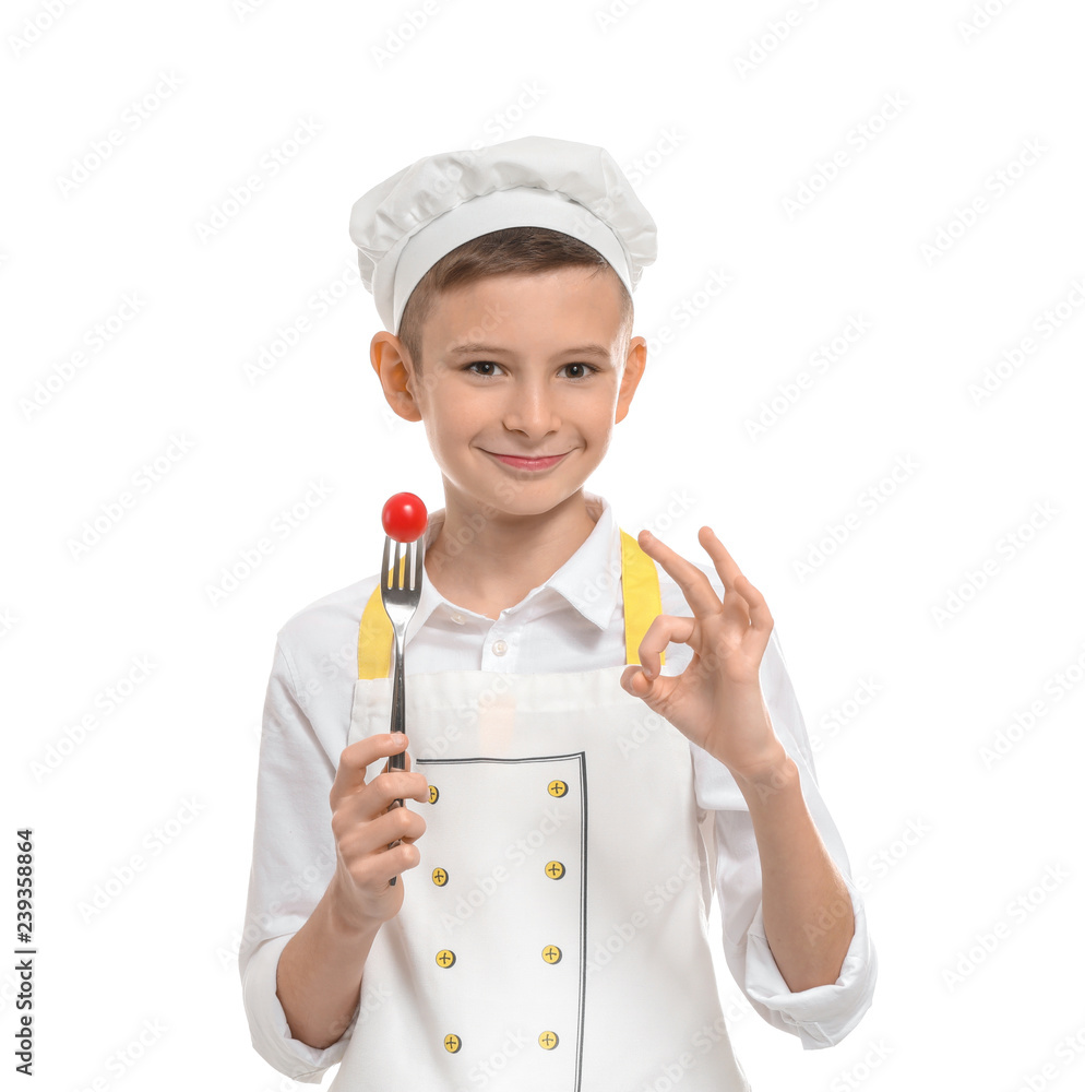 Cute little chef with tomato on fork showing OK gesture against white background Cute little chef with tomato on fork showing OK gesture against white background