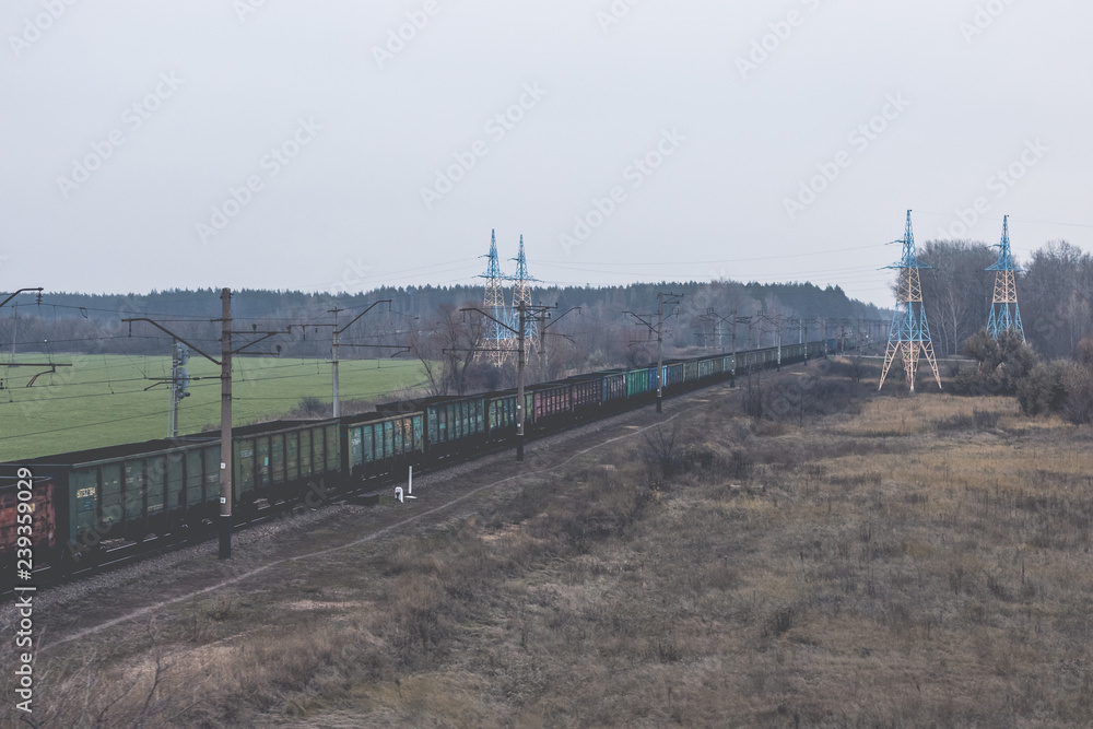 View from a bridge to a passing cargo train