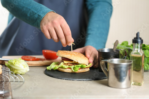 Male chef preparing burger in kitchen