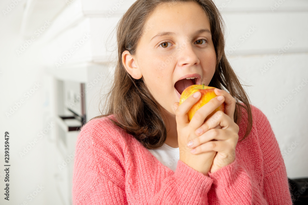 young teenage girl eating an apple young teenage girl eating an apple