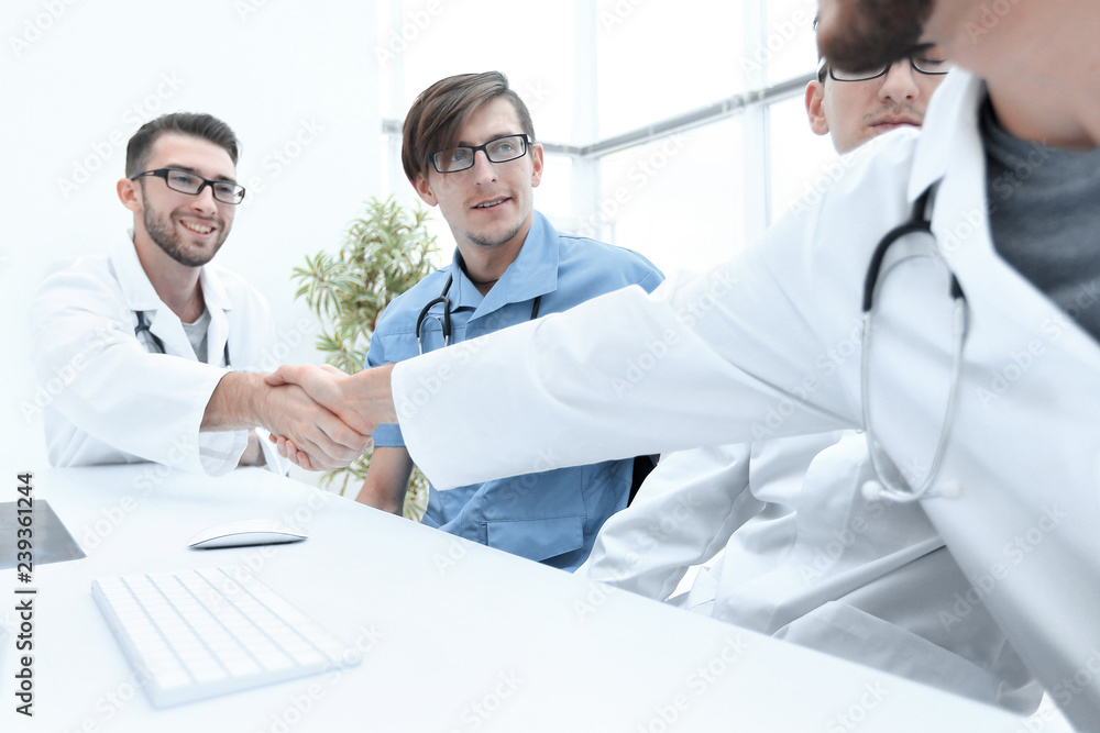 handshake between the two doctors during the working meeting handshake between the two doctors during the working meeting