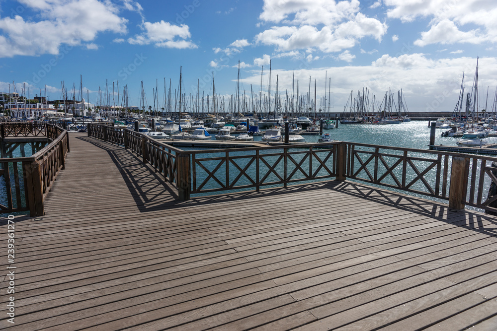 Wooden bridge at the boat harbor of Marina Rubicon in Playa Blanca. Lanzarote. Canary Island. Spain