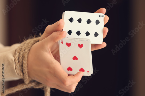 Woman with tied hands holdi...