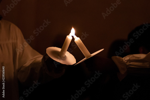 People handling candles in the hands. Christmas and lucia holidays in Sweden photo