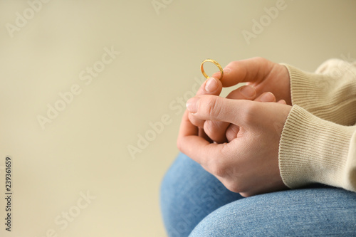 Woman holding ring, closeup. Concept of divorce photo
