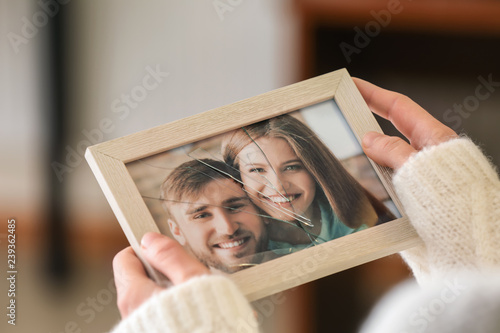 Woman holding photo of happ...