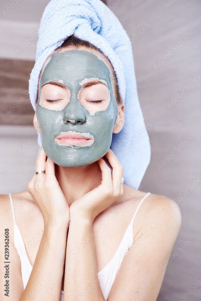 Woman applying mask moisturizing skin cream on face looking in bathroom mirror. Girl taking care of her complexion layering moisturizer. Skincare spa treatment. Woman applying mask moisturizing skin cream on face looking in bathroom mirror. Girl taking care of her complexion layering moisturizer. Skincare spa treatment.