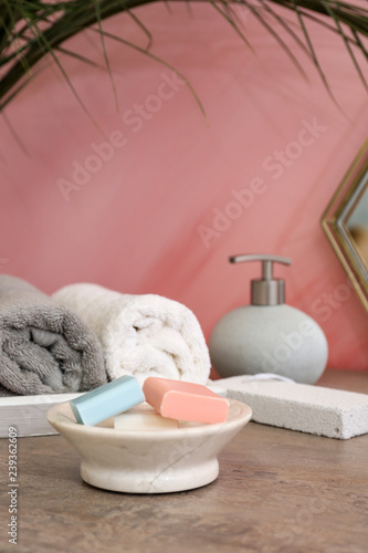 Towels and soap bars on table in bathroom