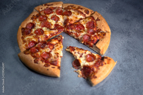 Fresh pepperoni pizza on grey