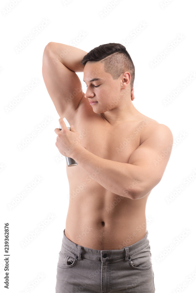 Young man using deodorant on white background Young man using deodorant on white background