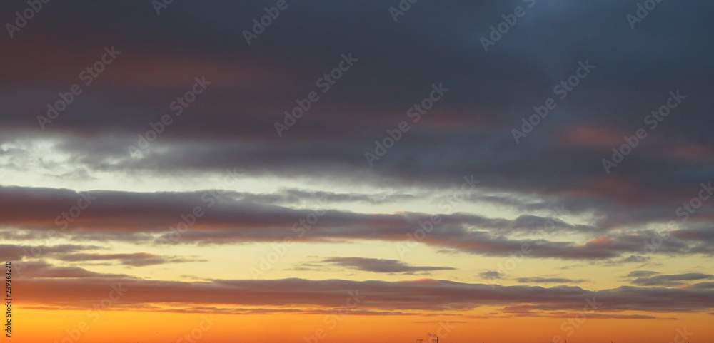 Beautiful colorful sunset with dark dramatic clouds, natural background Beautiful colorful sunset with dark dramatic clouds, natural background