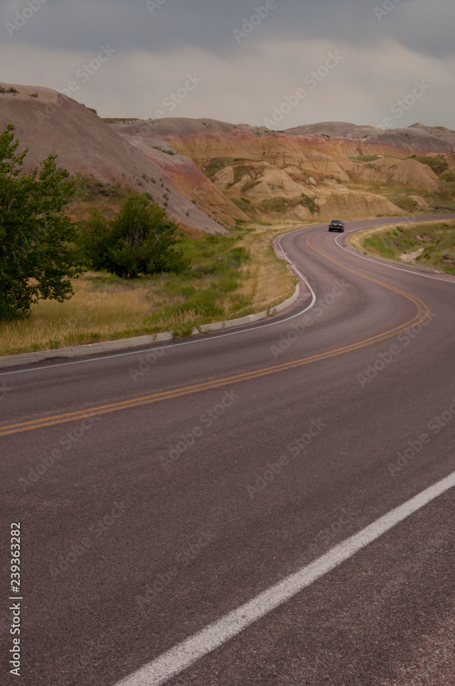 A Car Driving Through Badlands National Park A Car Driving Through Badlands National Park