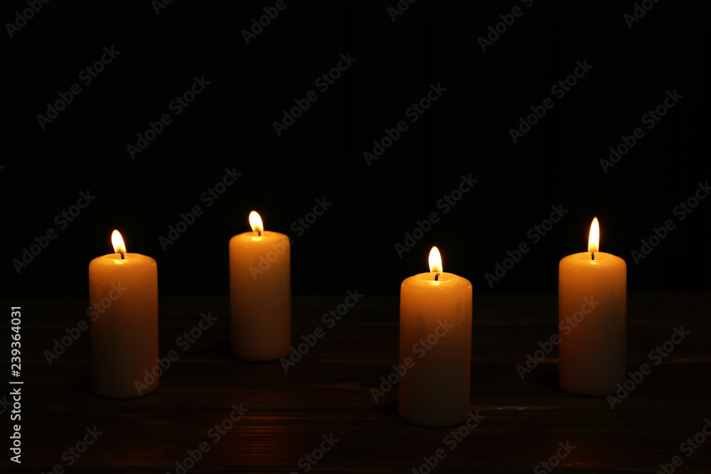Burning candles on dark background - obrazy, fototapety, plakaty 