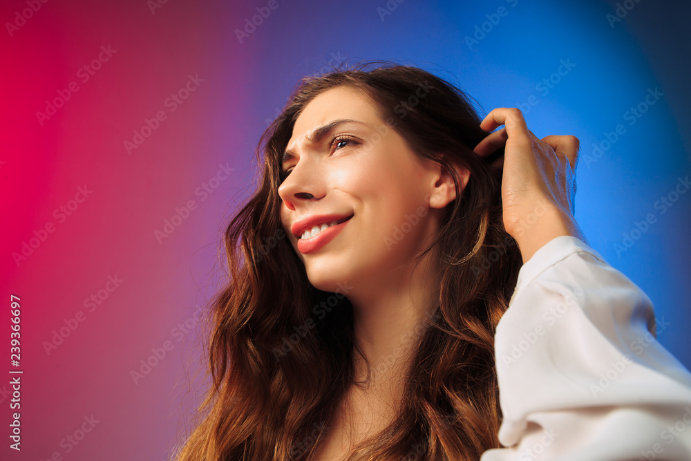 Happy woman standing, smiling on colored studio background. Beautiful female half-length portrait. Young satisfy woman. Human emotions, facial expression concept. Happy woman standing, smiling on colored studio background. Beautiful female half-length portrait. Young satisfy woman. Human emotions, facial expression concept.