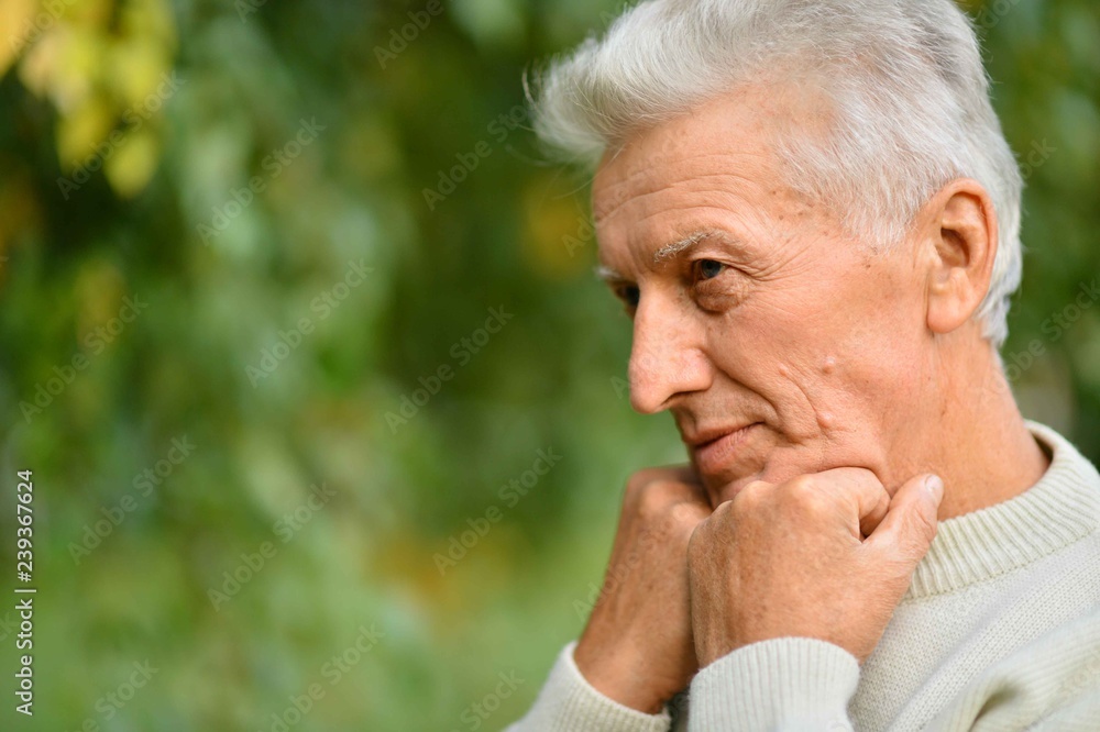 Portrait of thinking senior man on autumn background Portrait of thinking senior man on autumn background