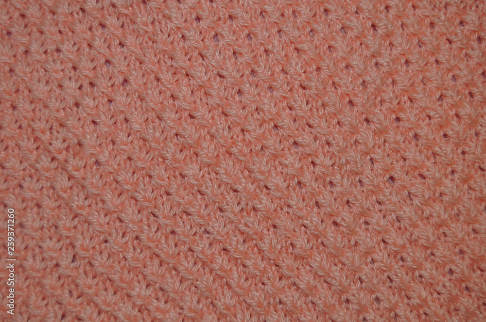 handwork. knitting. peach knitted fabric handwork. knitting. peach knitted fabric