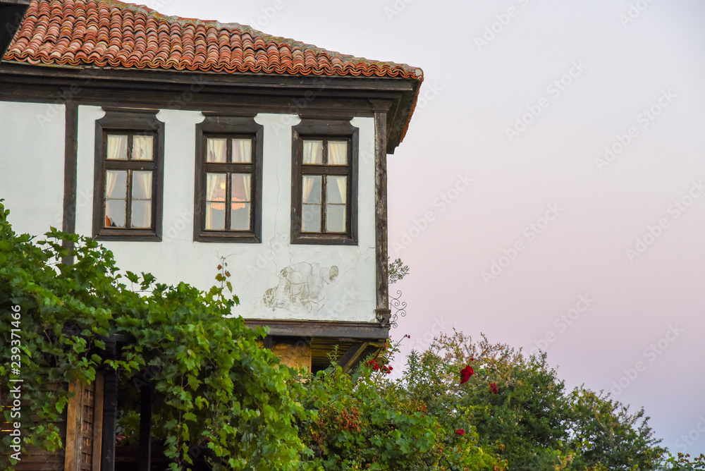 single Old house red tiled roof at sunset background