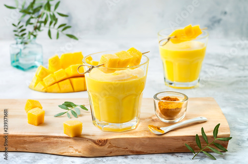 Mango Lassi, yogurt or smoothie with turmeric. Healthy probiotic Indian cold summer drink