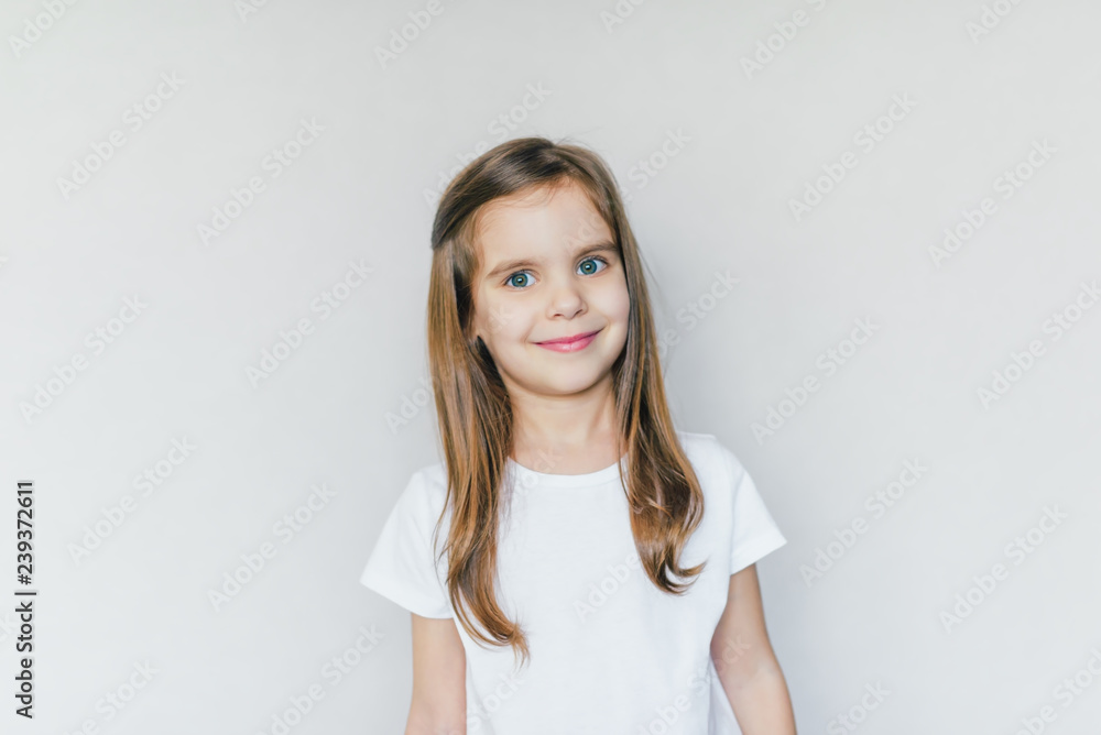 Portrait of beautiful happy baby girl isolated on grey background. Portrait of beautiful happy baby girl isolated on grey background.