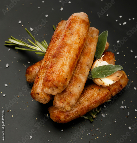 Grilled seasoned tastey sausages with a garlic and herb garnish