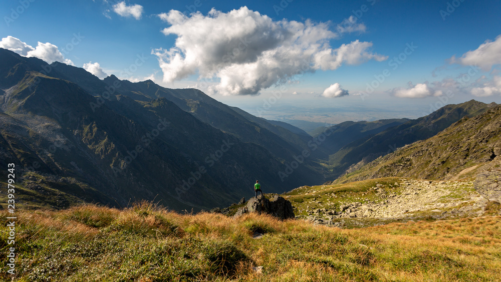 Young man backpacking through Fagaras mountains in Romania