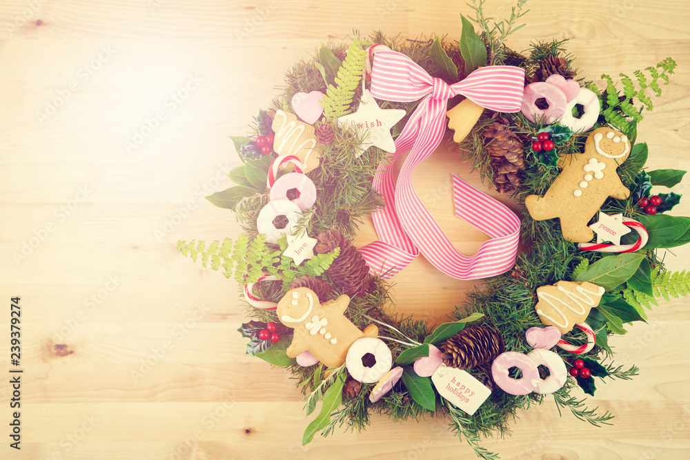 Christmas holiday wreath using fresh herbs, leaves, gingerbread, cookies, candy and gift tags with applied filters. Christmas holiday wreath using fresh herbs, leaves, gingerbread, cookies, candy and gift tags with applied filters.