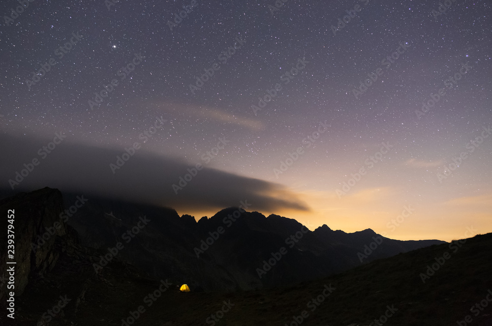 Stars rising above a tent in the mountains of Romania