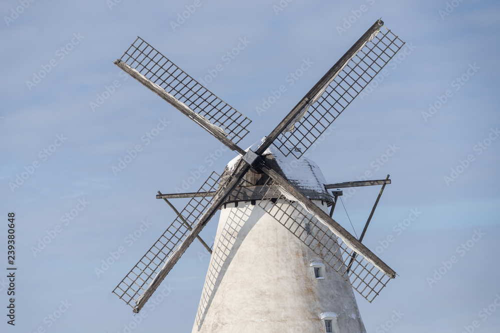 Grain mill on the winter landscape. Dutch windmill and natural background pattern