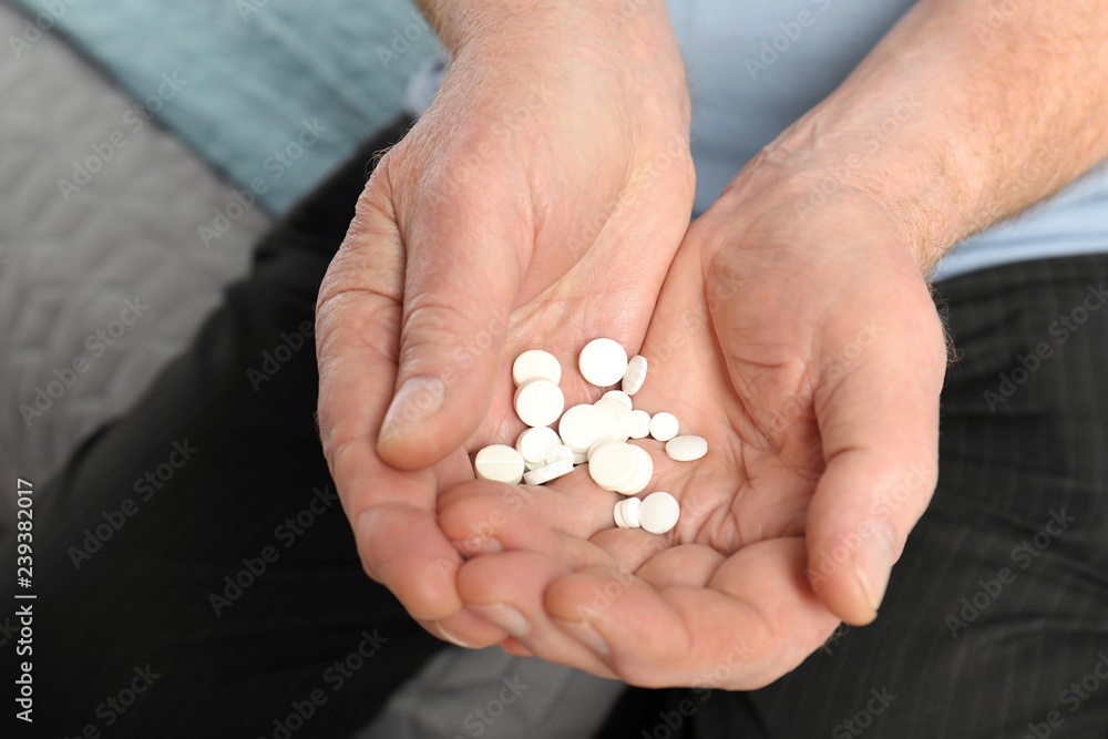 Senior man holding many pills in hands, closeup Senior man holding many pills in hands, closeup