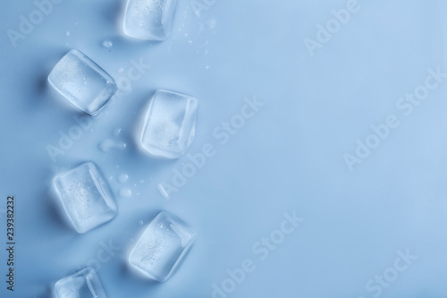 Ice cubes on color background, top view. Space for text