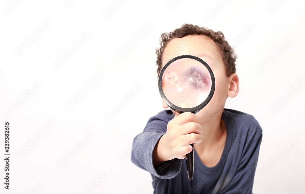 young boy with magnifying glass ready to explore young boy with magnifying glass ready to explore