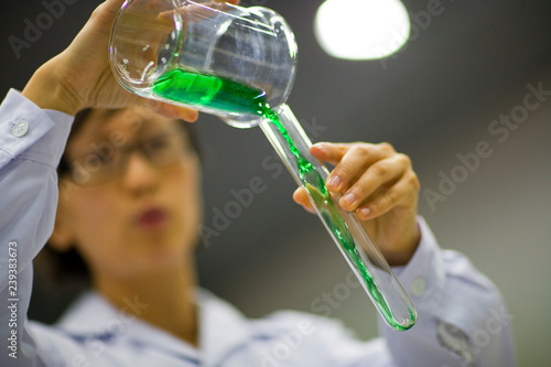 Liquid being poured into a test tube. photo