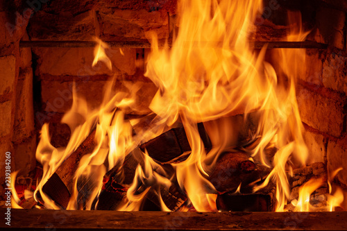 Burning firewood in the fireplace in the house, giving heat and heat. The concept of heating in the winter cold.