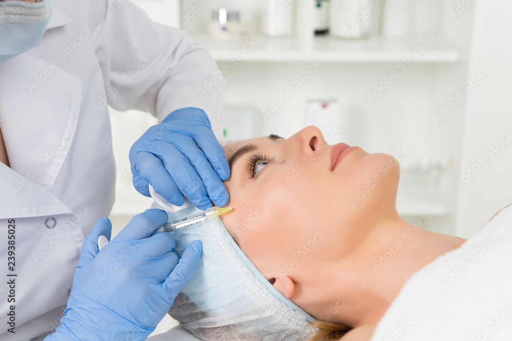 Fototapeta premium The doctor cosmetologist makes the Rejuvenating facial injections procedure for tightening and smoothing wrinkles on the face skin of a women in a beauty salon.Cosmetology skin care.