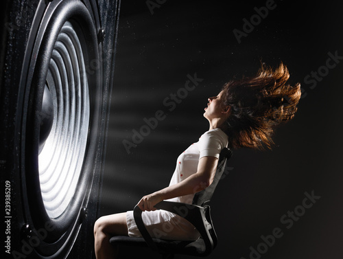 Photography The sound wave set back an office chair with young woman.
