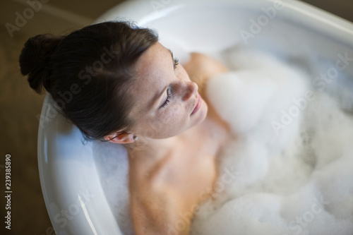 Woman enjoying relaxing bubble bath