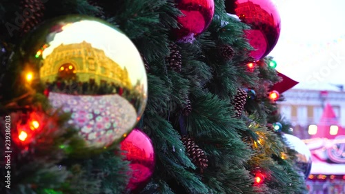 Red Square, Moscow, Russia - 15 December 2018. Christmas balls on the tree close up beside the Gum shopping center
