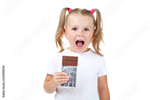 Happy little girl eating chocolate on white background