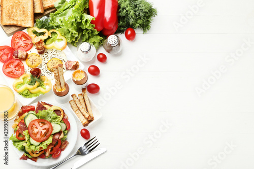 Tasty breakfast on white wooden table photo