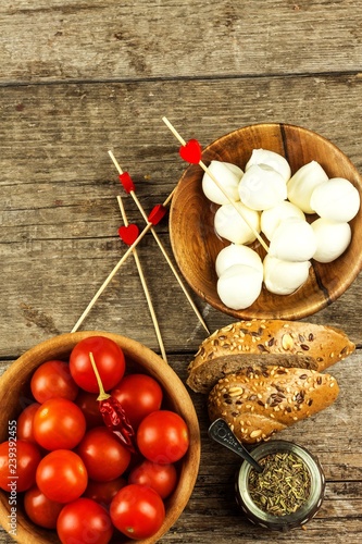 Traditional Italian Mozzarella cheese on a wooden board. Healthy cheese. Dairy products. Mozzarella cheese balls with tomatoes. Diet food.