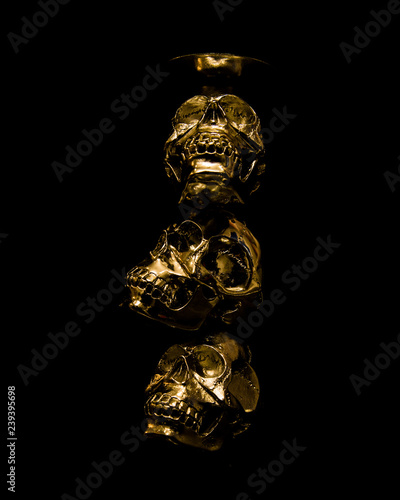 Golden Skulls - 3 skull gold with dark background photo