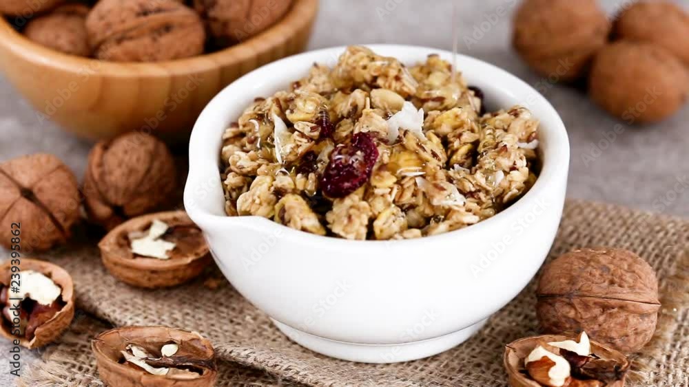 Bowl of homemade granola with nuts and honey. Horizontal view Bowl of homemade granola with nuts and honey. Horizontal view