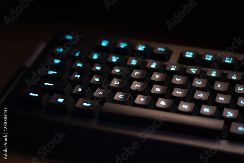 Keyboard with blue backlight on work table, button lights