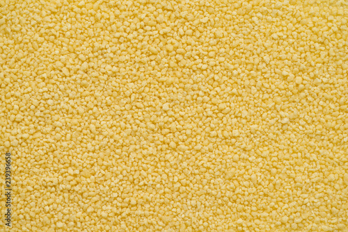 Couscous is a steamed balls of crushed durum wheat semolina. Couscous is a staple food throughout the North African cuisines. Top view  abstract background for your design