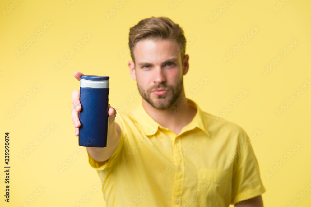 Hair care concept. Effective shampoo. Try this shampoo. Best shampoo for your hair type. Make hair stronger and more resilient. Man handsome bearded hipster hold plastic bottle shampoo or shower gel Hair care concept. Effective shampoo. Try this shampoo. Best shampoo for your hair type. Make hair stronger and more resilient. Man handsome bearded hipster hold plastic bottle shampoo or shower gel