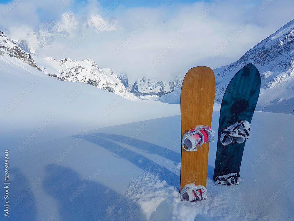Φωτογραφία Two snowboards are stuck in the high powder snow at the top of the mountain