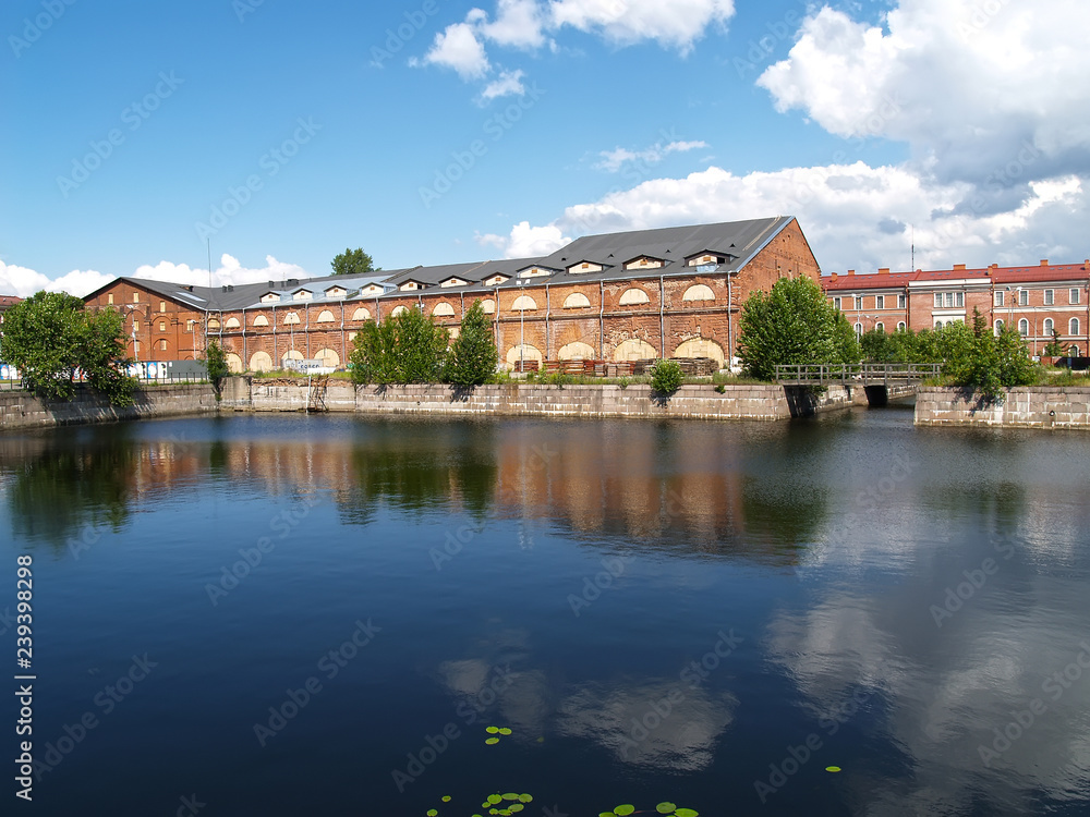 ST. PETERSBURG, RUSSIA. A view of warehouse buildings and a pond in summer day. Island New Holland